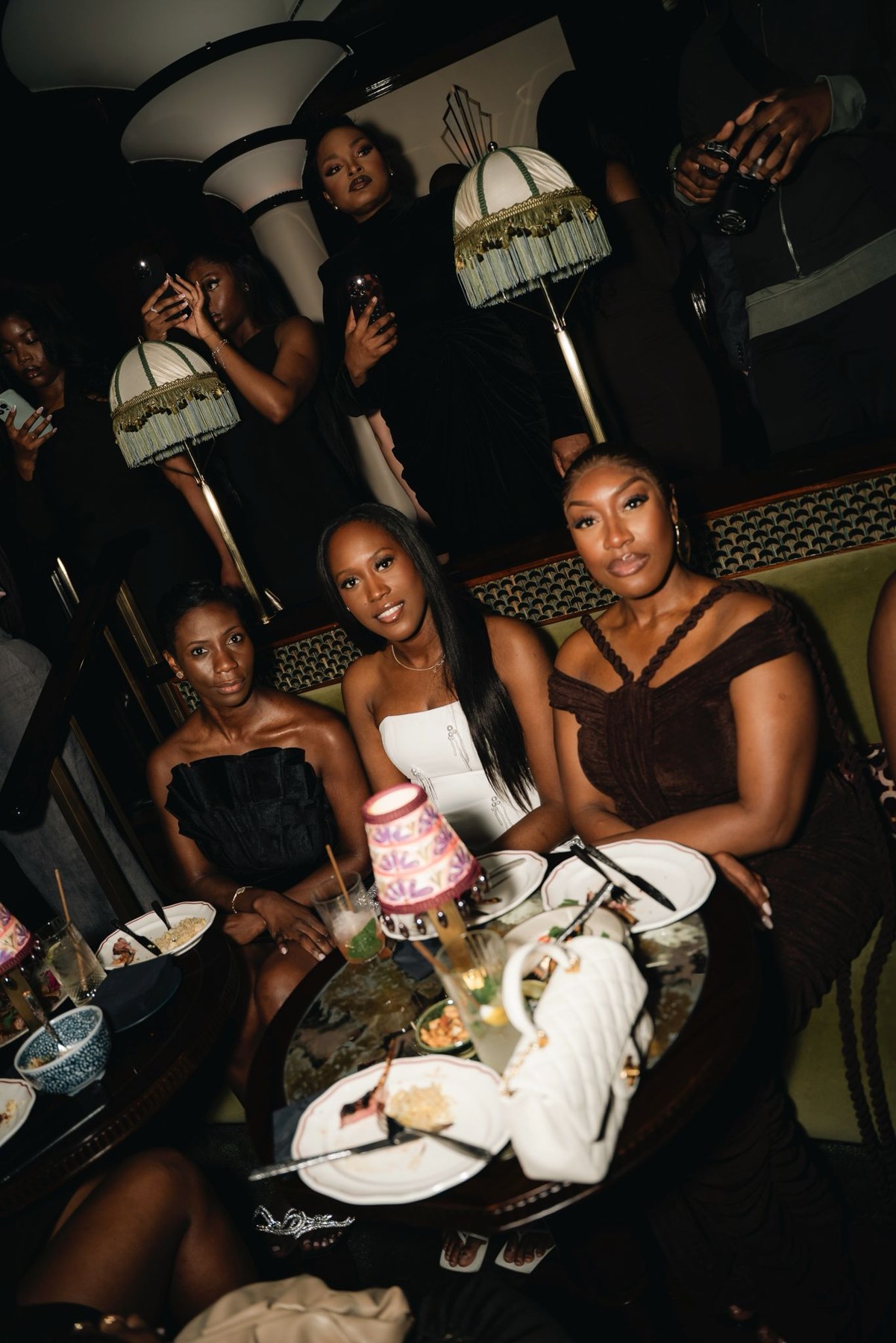 Guests gathered around a candlelit table at the last celebration